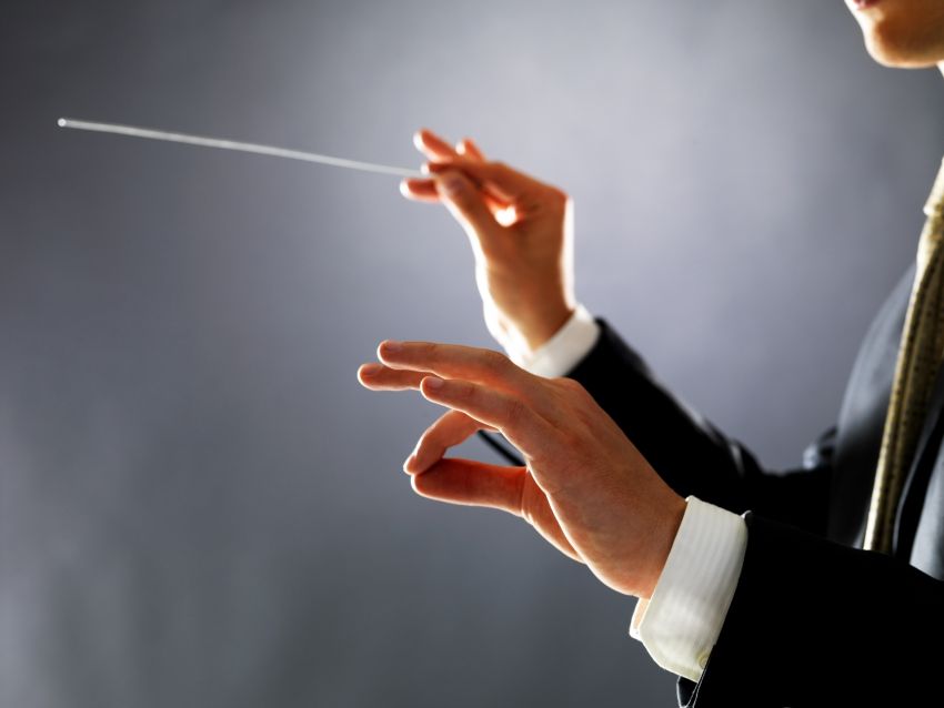 conductor leading an orchestra