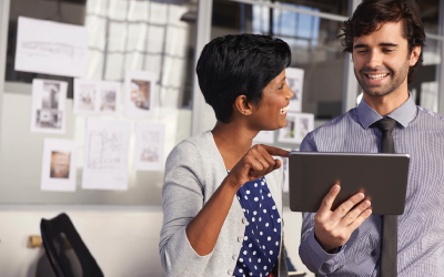 Two employees discussing what's on a tablet screen