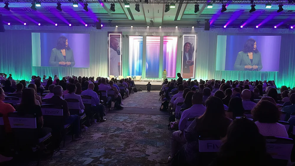 Stage and crowd at a customer experience event