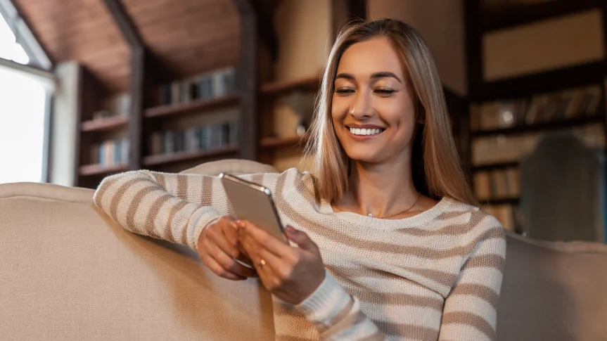 Woman sitting on a couch using her phone
