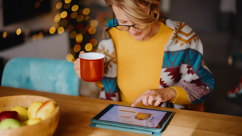 Woman shopping on her tablet at home