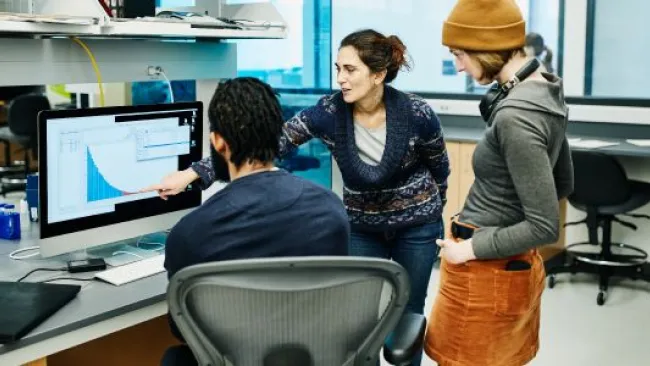3 people analyzing data