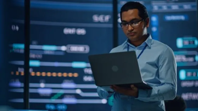 A man seriously looking at his laptop