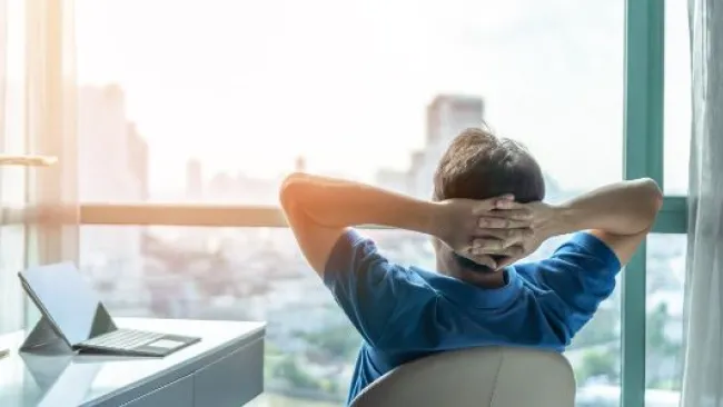 A man resting while looking at his window
