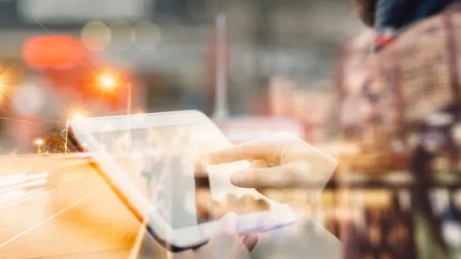 A person with a tablet and a highway