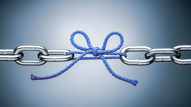 Links in a chain, with one link missing and replaced by a bow