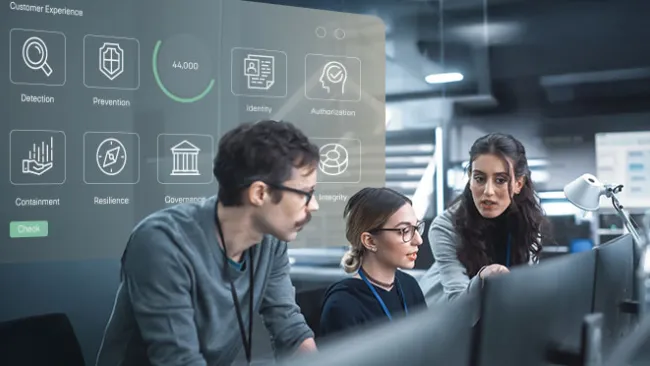 A man and two women looking at computer screen, with security/lock-related images projected behind them 