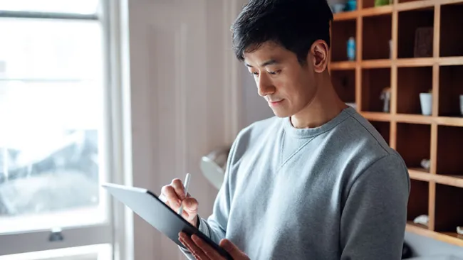 A guy doing something on his iPad