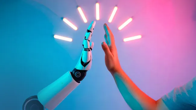 Person high-fiving an android