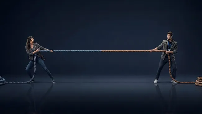 Two people tugging at opposite ends of a rope