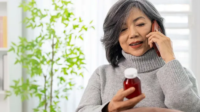 A customer talking on the phone about her prescription