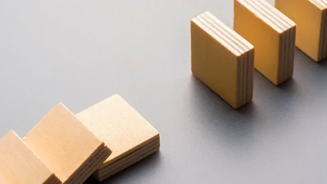 A disconnected line of dominoes that's started to fall but has a gap in it