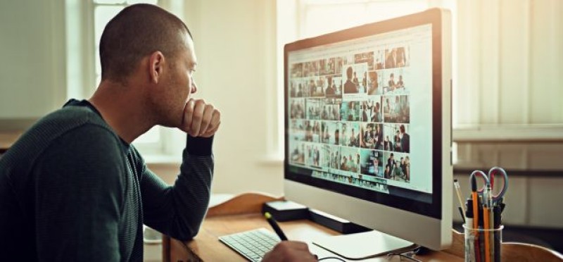 A man looking at his monitor
