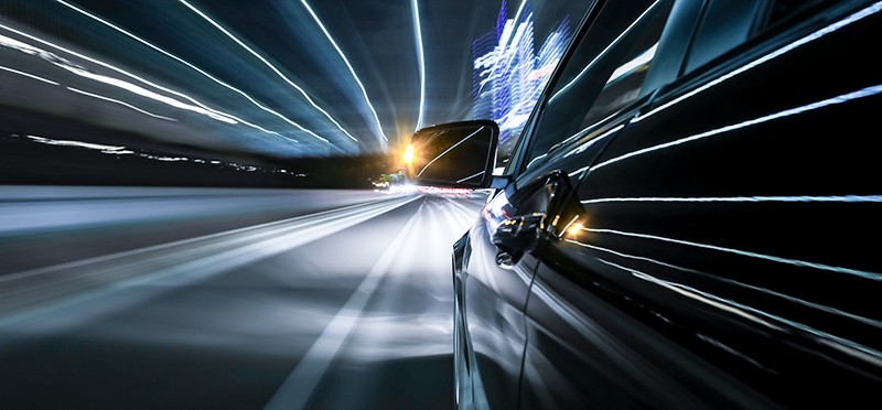 A car driving quickly with it's blinker on