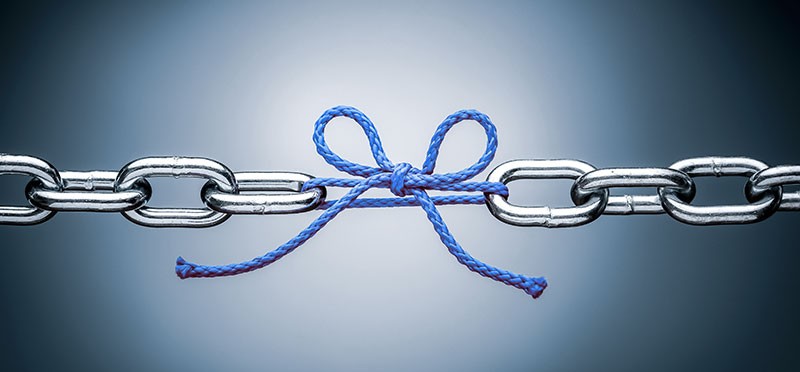 Links in a chain, with one link missing and replaced by a bow