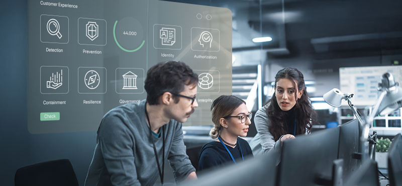 A man and two women looking at computer screen, with security/lock-related images projected behind them 