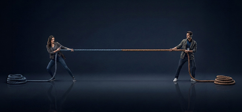 Two people tugging at opposite ends of a rope
