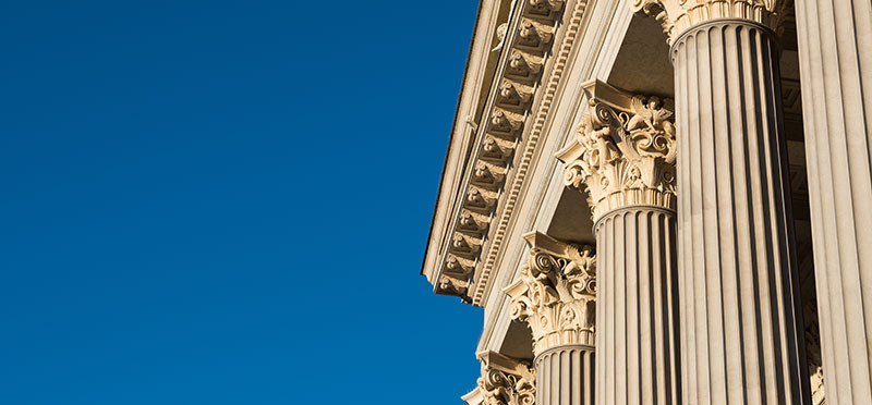 White facade of a government building with columns 