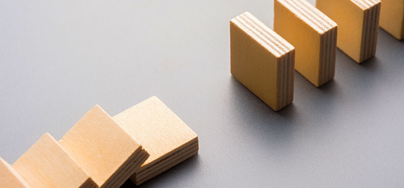 A disconnected line of dominoes that's started to fall but has a gap in it