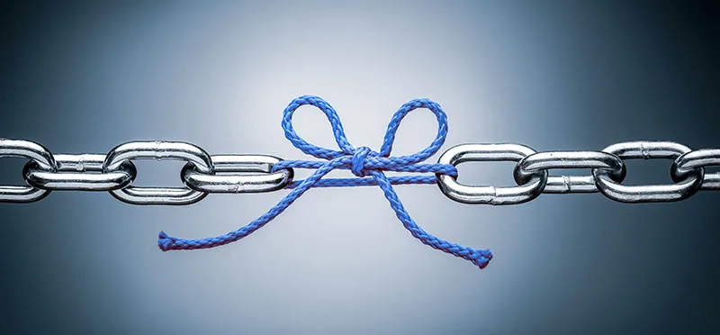 Links in a chain, with one link missing and replaced by a bow