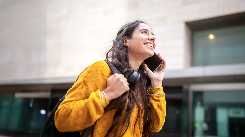 A woman on her phone outside the building