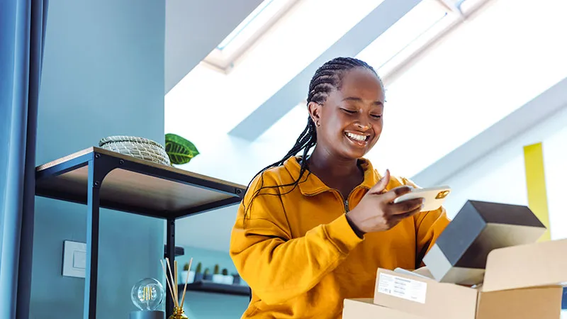 A woman who looks happy with the package she received