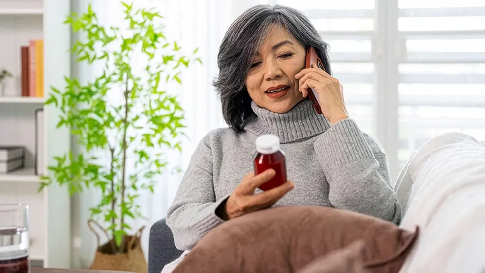 A customer talking on the phone about her prescription