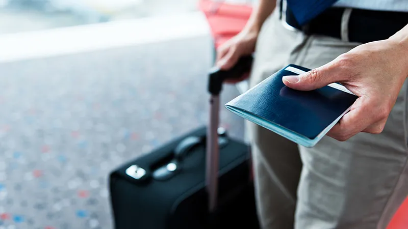 A man handing out his passport