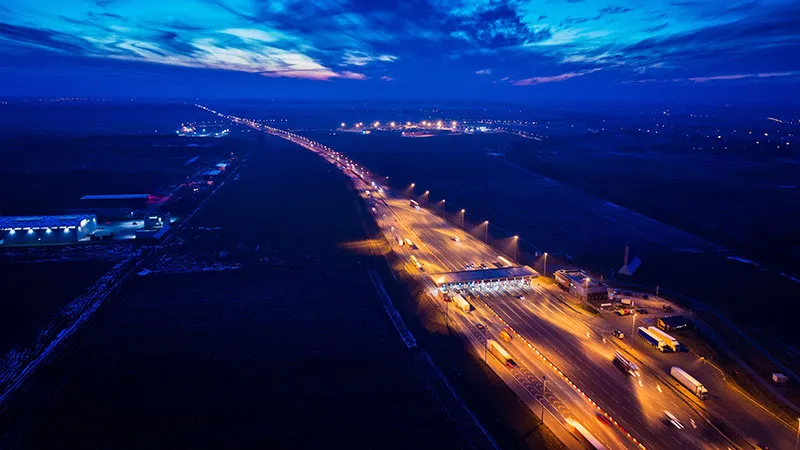 An aerial drone view of a highway toll plaza